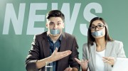 News presenters with taped mouths on TV